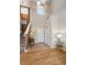 Welcoming foyer with hardwood floors, high ceilings, and staircase leading to the upper level at 6024 W Colorado Ln, Lakewood, CO 80232