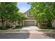 Charming home with a two-car garage, well-manicured lawn, mature trees, and a welcoming entrance at 6024 W Colorado Ln, Lakewood, CO 80232