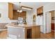 Bright kitchen with wood cabinets, an island, and modern appliances at 6024 W Colorado Ln, Lakewood, CO 80232