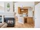 Open kitchen features wood cabinets and an island overlooking the fireplace at 6024 W Colorado Ln, Lakewood, CO 80232
