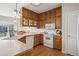 Kitchen with oak cabinets, stainless steel appliances, and a view of the backyard at 6024 W Colorado Ln, Lakewood, CO 80232