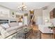 Bright living room featuring a fireplace, chandelier, and staircase at 6024 W Colorado Ln, Lakewood, CO 80232
