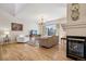 Comfortable living room with a fireplace, hardwood floors, and large window at 6024 W Colorado Ln, Lakewood, CO 80232