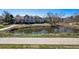 A scenic view of townhomes overlooking a pond with walking paths at 6024 W Colorado Ln, Lakewood, CO 80232
