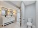 Bright bathroom offers a toilet and large vanity, tiled floor, and opens up to a secondary room at 9371 Princeton Ln, Highlands Ranch, CO 80130