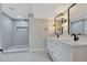 Modern bathroom features double vanity, tile floors, a new shower, and updated fixtures at 9371 Princeton Ln, Highlands Ranch, CO 80130