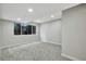 This bedroom has gray carpet and walls, a window, and recessed lights at 9371 Princeton Ln, Highlands Ranch, CO 80130