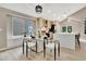 Modern kitchen with a glass top dining table, quartz countertops, and stainless steel appliances at 9371 Princeton Ln, Highlands Ranch, CO 80130