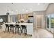 Open kitchen featuring a spacious island with barstool seating, modern appliances, and sleek cabinetry at 9371 Princeton Ln, Highlands Ranch, CO 80130