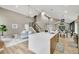 Spacious living area showcasing an open layout, a modern kitchen island, and stylish staircase at 9371 Princeton Ln, Highlands Ranch, CO 80130