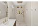 This walk-in shower features unique gold shower heads, and accents along the tiled walls and floor at 9371 Princeton Ln, Highlands Ranch, CO 80130