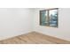 Empty bedroom featuring hardwood floors and a large window at 1 Winged Foot Way, Littleton, CO 80123