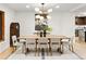 Bright dining room with a modern chandelier, art piece, and seating for six around a wood table at 1 Winged Foot Way, Littleton, CO 80123