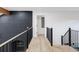 Hallway with dark brick wall and modern railings at 1 Winged Foot Way, Littleton, CO 80123