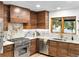 Gourmet kitchen with wood cabinets, stainless steel appliances, and marble countertops at 1 Winged Foot Way, Littleton, CO 80123