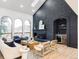 Cozy living room with a painted brick fireplace, skylight, arched windows, and light wood floors at 1 Winged Foot Way, Littleton, CO 80123