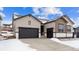 Beige and brown two-story house with dark garage door and snowy landscape at 16850 Mckay Dr, Mead, CO 80542