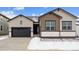 Two-toned house with dark brown garage door and snowy front yard at 16850 Mckay Dr, Mead, CO 80542