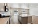 Modern kitchen with stainless steel appliances and eat-in island at 16850 Mckay Dr, Mead, CO 80542