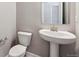 Convenient powder room with pedestal sink and toilet at 16850 Mckay Dr, Mead, CO 80542