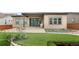Spacious backyard featuring lush green lawn, mature trees, a patio with seating and slider to interior space at 11193 Mission Walk St, Parker, CO 80134