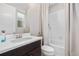 Bright bathroom features a white vanity, tiled shower-tub and ample natural light from the window at 11193 Mission Walk St, Parker, CO 80134
