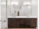 Modern bathroom with double sinks, dark cabinets, and a frameless glass shower at 11193 Mission Walk St, Parker, CO 80134
