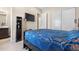 A comfortable bedroom with closet, TV and a dark wood shelf for storage at 11193 Mission Walk St, Parker, CO 80134