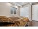This bedroom has an egress window and features hardwood floors and sliding closet doors at 11193 Mission Walk St, Parker, CO 80134