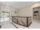 Hallway with white floors and wood stair rails at 11193 Mission Walk St, Parker, CO 80134