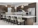 Modern kitchen with a large center island, stainless steel appliances, and stylish pendant lighting at 11193 Mission Walk St, Parker, CO 80134
