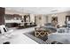 Open-concept living room featuring a modern kitchen, stylish furniture, and elegant decor throughout the space at 11193 Mission Walk St, Parker, CO 80134