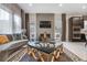 Comfortable living room featuring a fireplace, modern decor, and access to other parts of the home at 11193 Mission Walk St, Parker, CO 80134
