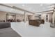 Large living room with sofas, recessed lighting, white epoxy floors, and a walkout at 11193 Mission Walk St, Parker, CO 80134