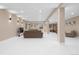 Living room with white epoxy floors, recessed lighting, and neutral decor at 11193 Mission Walk St, Parker, CO 80134