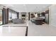 Bright and airy living space featuring a modern kitchen with stainless appliances, fireplace, and tile floors at 11193 Mission Walk St, Parker, CO 80134