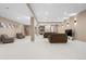 Large living room with recessed lights, neutral walls, and neutral furniture at 11193 Mission Walk St, Parker, CO 80134