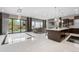 Open-concept living room featuring large windows, modern decor, and seamless flow to the backyard at 11193 Mission Walk St, Parker, CO 80134