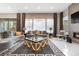 Bright living room featuring modern furniture, a cozy fireplace, and large windows with elegant drapes at 11193 Mission Walk St, Parker, CO 80134