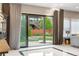 Open living space with a backyard view, stone floors, and lots of natural light at 11193 Mission Walk St, Parker, CO 80134
