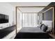 A bedroom showcasing sleek black walls and modern furnishings, illuminated by natural light from the large window at 3100 E Cherry Creek South Dr # 1201, Denver, CO 80209