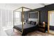 Modern bedroom with a four-poster bed, sleek black walls, and bright window at 3100 E Cherry Creek South Dr # 1201, Denver, CO 80209