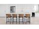 Modern kitchen island with bar stool seating and stainless steel appliances at 3100 E Cherry Creek South Dr # 1201, Denver, CO 80209