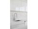 Modern kitchen sink with white countertops and backsplash at 3100 E Cherry Creek South Dr # 1201, Denver, CO 80209