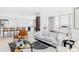 Bright living room with large windows and modern furniture next to kitchen at 3100 E Cherry Creek South Dr # 1201, Denver, CO 80209