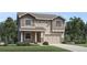 Inviting two-story home featuring neutral siding, a two-car garage, and a well-maintained front lawn at 6312 Las Conchas Pt, Parker, CO 80134