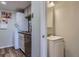 Bathroom and laundry room featuring updated cabinets, sink and appliances at 3354 S Flower St # 14, Lakewood, CO 80227