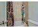 Tiled bathtub/shower combination with a shower caddy for easy access to toiletries at 3354 S Flower St # 14, Lakewood, CO 80227