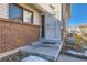 Close-up of a home entrance with red brick and a white security door at 3354 S Flower St # 14, Lakewood, CO 80227