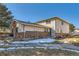 Two-story home featuring a brick foundation and light siding under a blue sky at 3354 S Flower St # 14, Lakewood, CO 80227